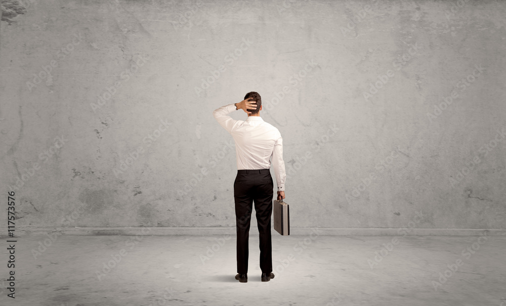 Businessman lost in empty urban space Businessman lost in empty urban space
