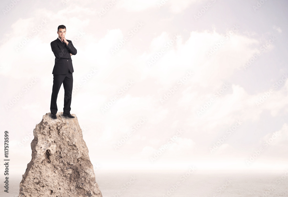 Happy businessman standing on cliff Happy businessman standing on cliff