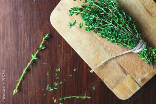 Fresh green bunch of thyme on wooden background