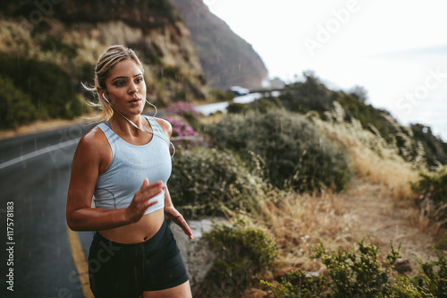 Fototapeta Naklejka Na Ścianę i Meble -  Fitness woman running outdoors in countryside