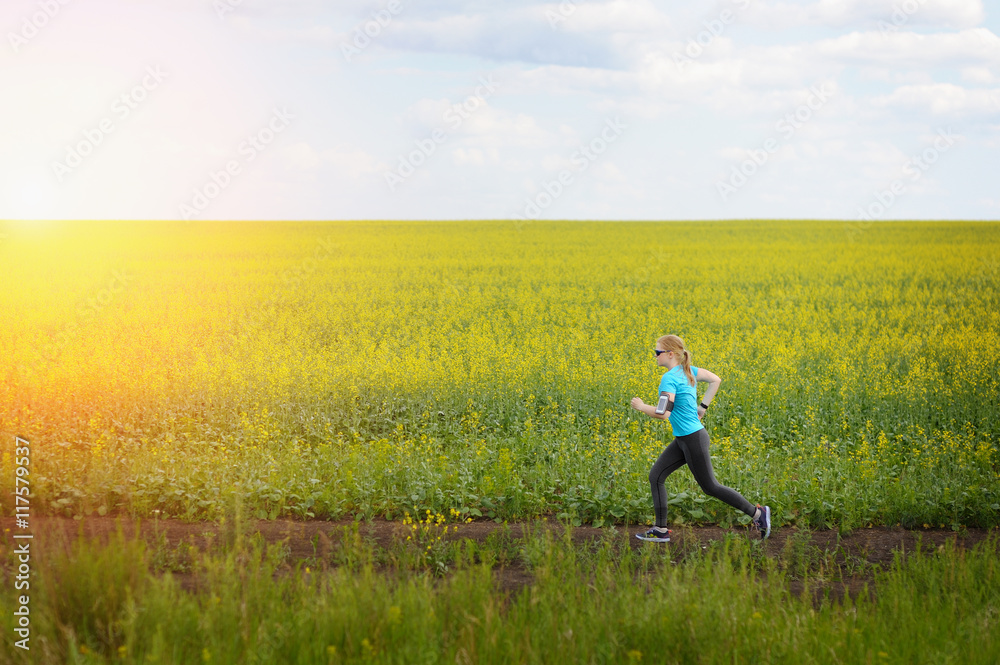 Runner woman running on road in beautiful nature. Runner woman running on road in beautiful nature.