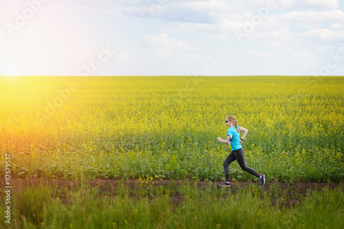 Runner woman running on road in beautiful nature.