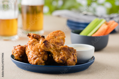 Barbecue hot chicken wings with beers at pub garden photo
