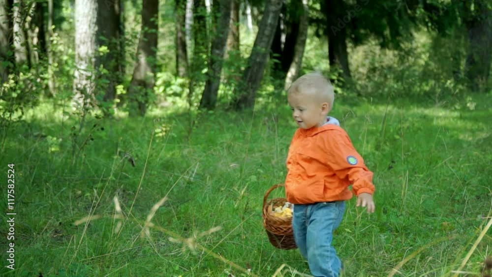 Funny little boy of 1.5 years bears in the mushrooms in the basket Funny little boy of 1.5 years bears in the mushrooms in the basket