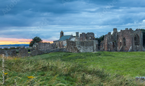 Lindisfarne Priory on Holy Island, Northumberland, England, UK. At sunset, blue hour.