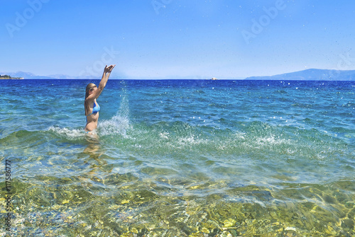 greek girl iside the sea playing with the waves at Euboea Greece