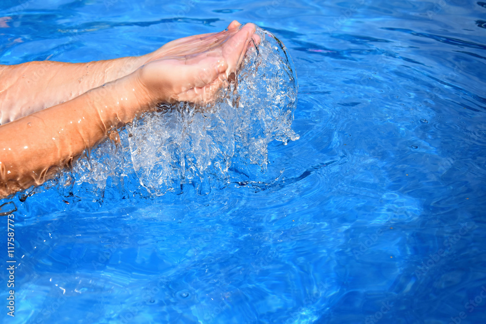 Above the pool of human two hands overflowing water