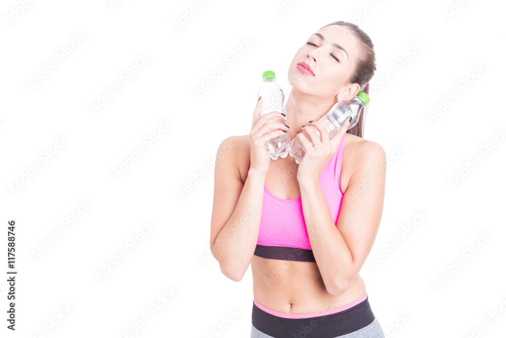 Lady at gym refreshing with two bottles of water Lady at gym refreshing with two bottles of water