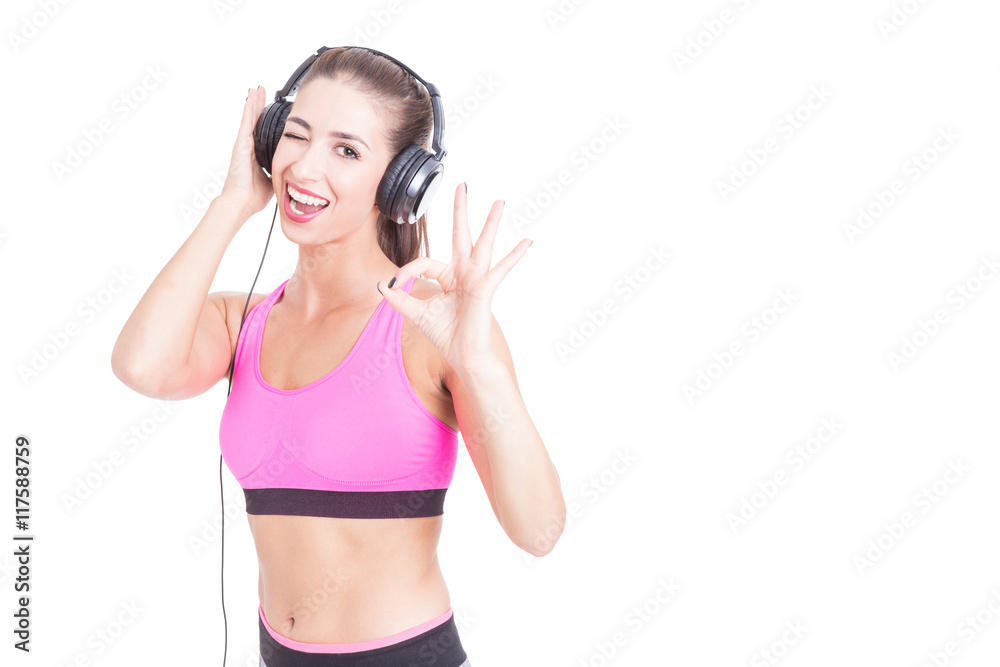 Girl wearing sportswear and headphones winking Girl wearing sportswear and headphones winking