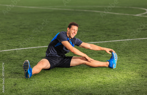 athlete stretching and smiling