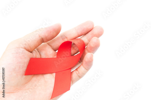 Hand hold red ribbon on white background for AIDs awareness concept