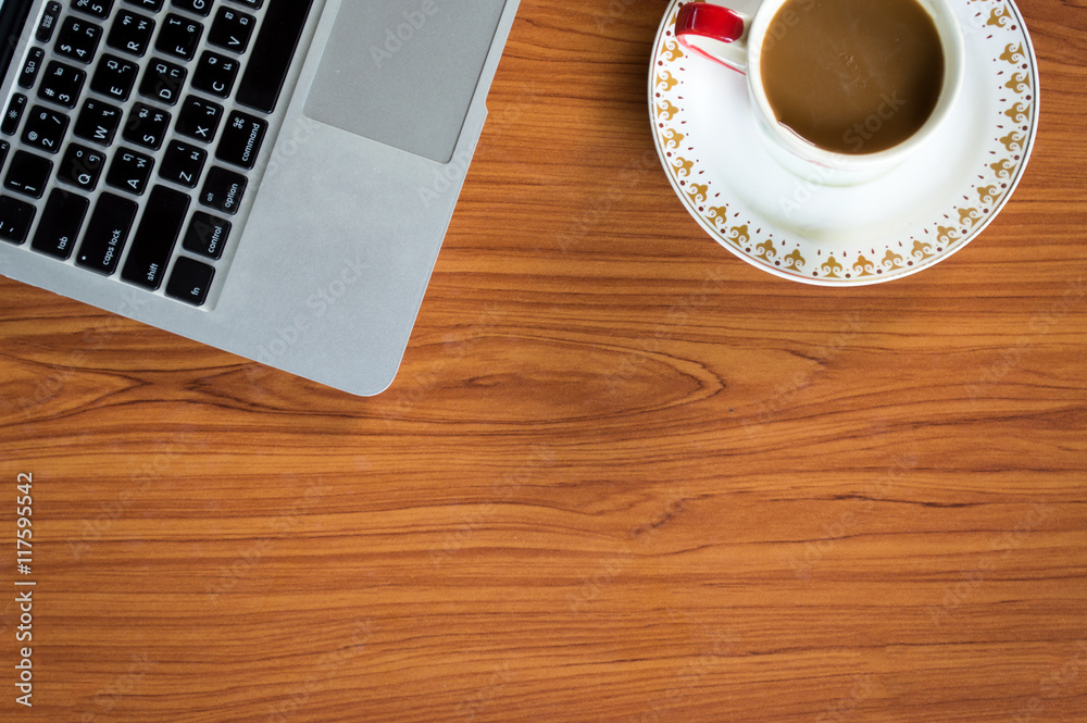 Office table with notepad, laptop and coffee cup.View from above with copy space.


