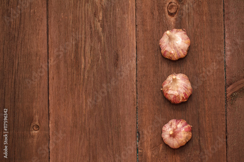 Ripe garlic head on a wooden background