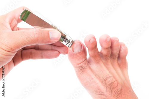 Man hand cut toenails on white background  health care concept
