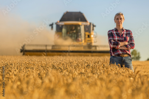 Tela female farmer and combine harvester