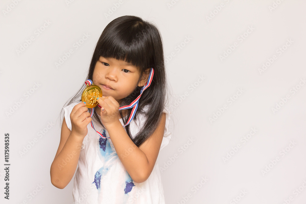 asian child holdind golden medal and thinking asian child holdind golden medal and thinking