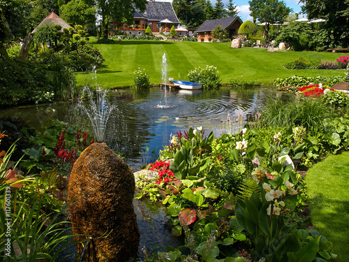 Ornamental pond and water fountain in a garden