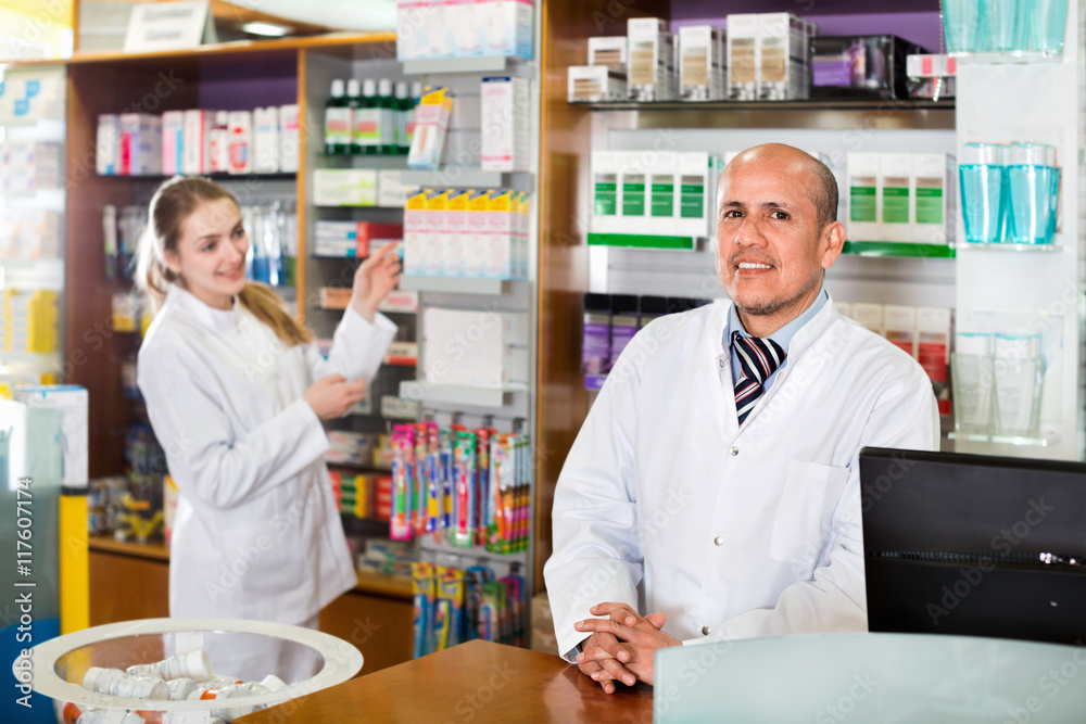 Fototapeta premium Professional pharmaceutists at reception of drugstore