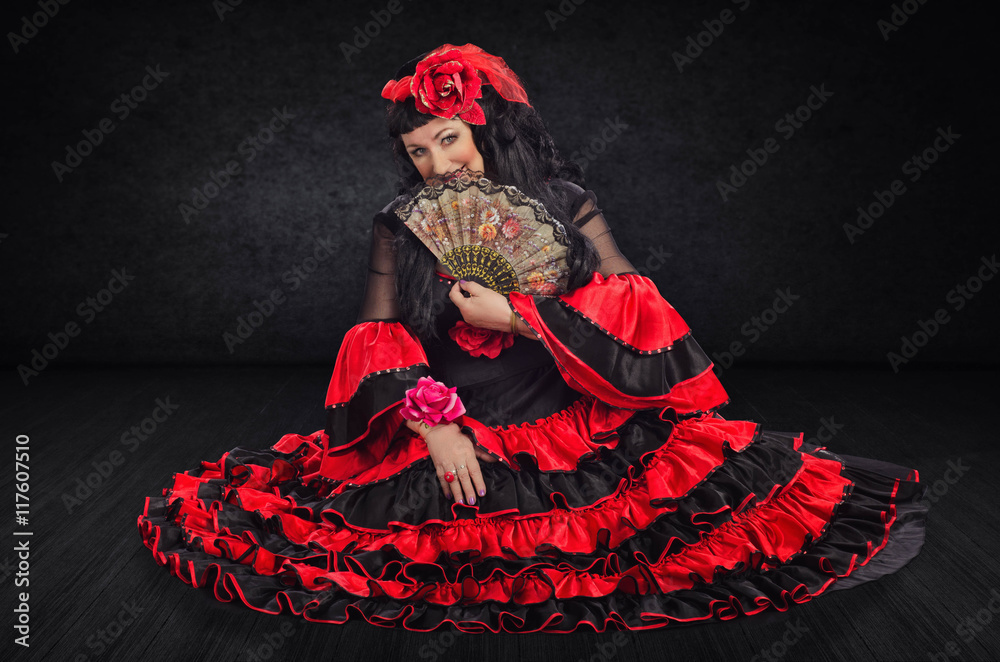 Mature dancer on floor closes her face with fan Mature dancer on floor closes her face with fan