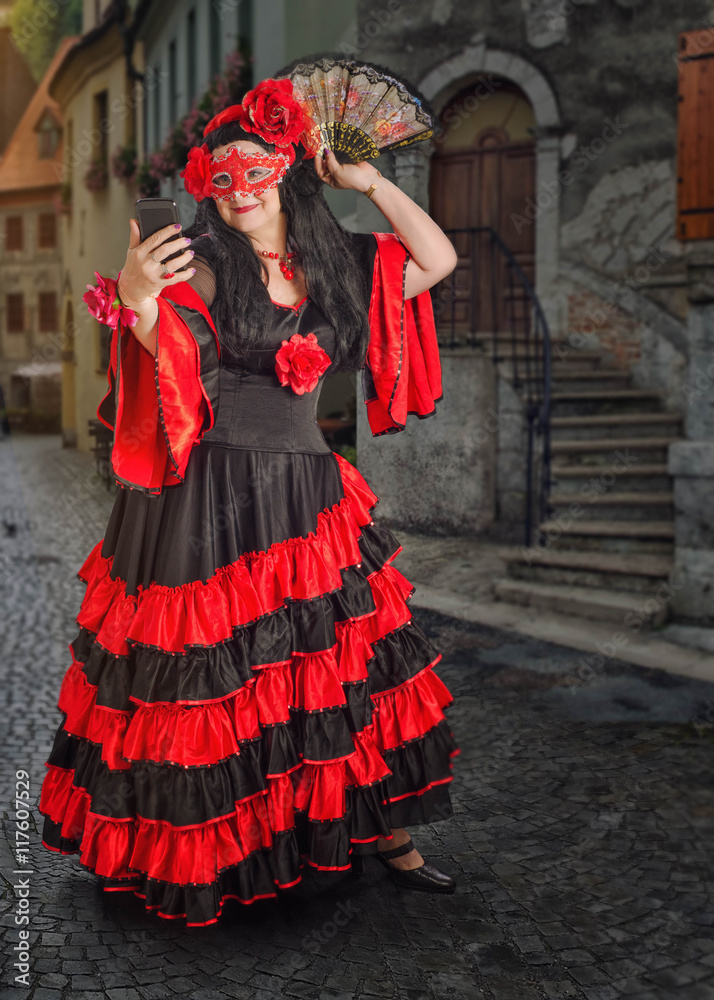 Masked flamenco dancer taking photo with phone Masked flamenco dancer taking photo with phone