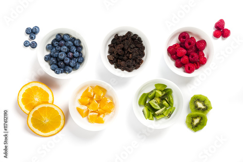 Set of white bowls full of dried and fresh fruit arranged as five olympic rings