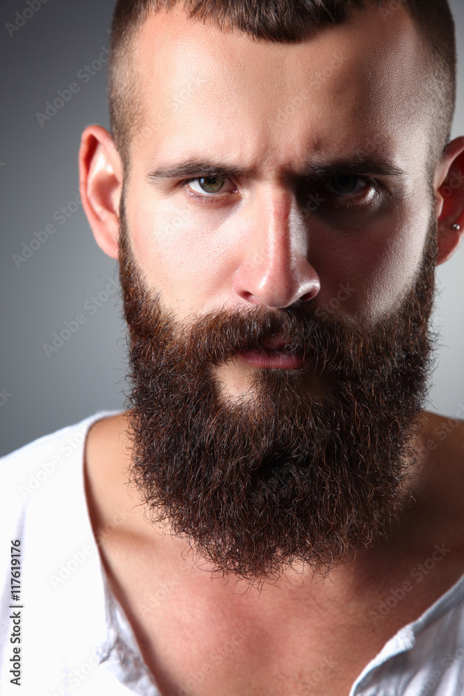 Portrait of handsome man standing, isolated on grey background Portrait of handsome man standing, isolated on grey background