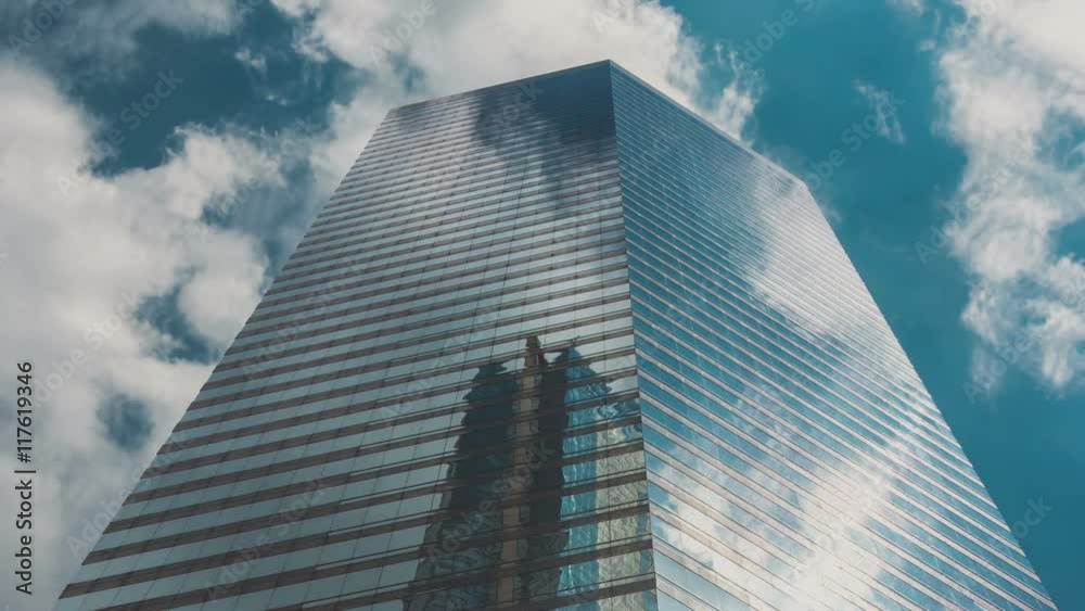 Corporate Buildings, Blue Sky and Clouds Mirrored in Skyscraper Corporate Buildings, Blue Sky and Clouds Mirrored in Skyscraper
