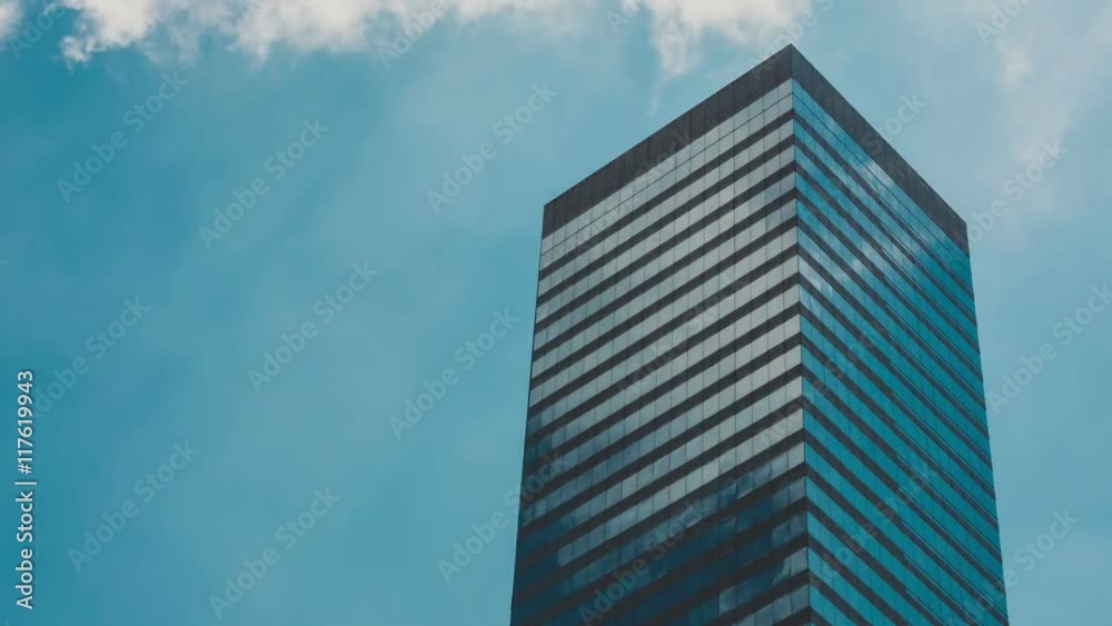 Corporate Buildings, Blue Sky and Clouds Mirrored in Skyscraper Corporate Buildings, Blue Sky and Clouds Mirrored in Skyscraper