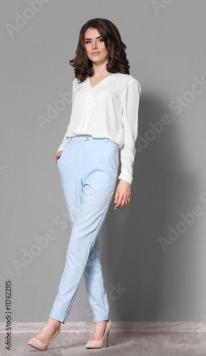 Pretty woman on grey backgr...