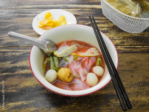 Noodles with seafood soup and red sauce.
