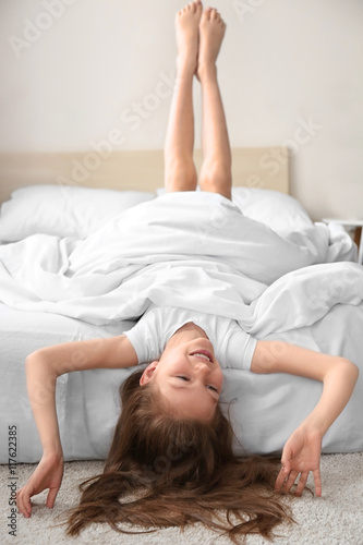 Cute funny girl in white bed