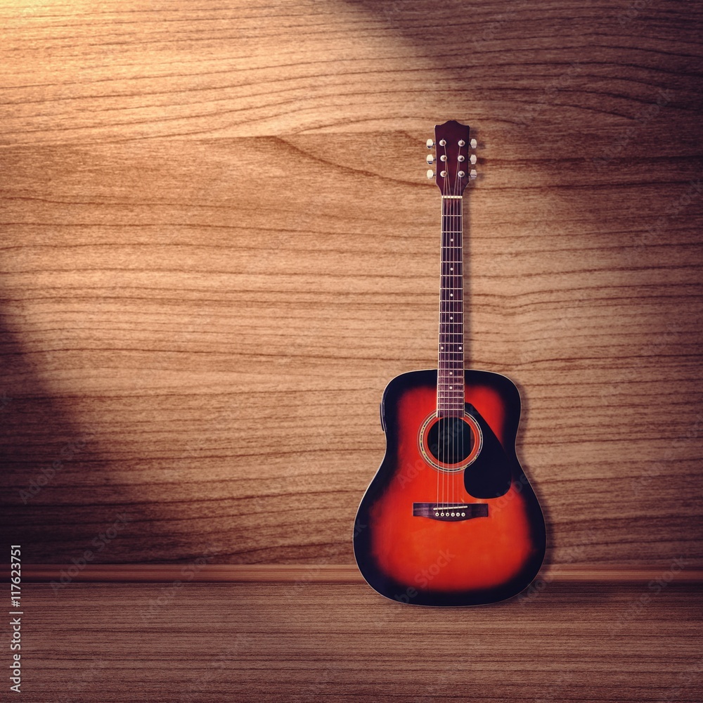 Naklejka premium Classical guitar on wood background