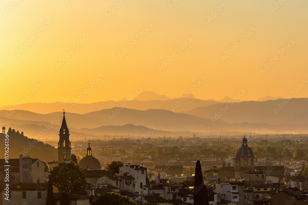 View of Florence in Tuscany at sunset with mountains in the background
