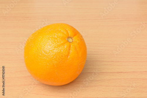 Single orange on table background