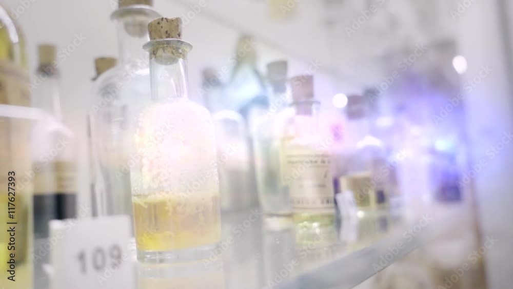 Old medicine bottles labeled for each disease, in showcase Old medicine bottles labeled for each disease, in showcase