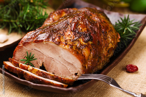 Roast pork with herbs and vegetables.