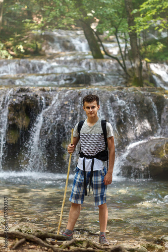 Hiker boy near a waterfall © Xalanx
