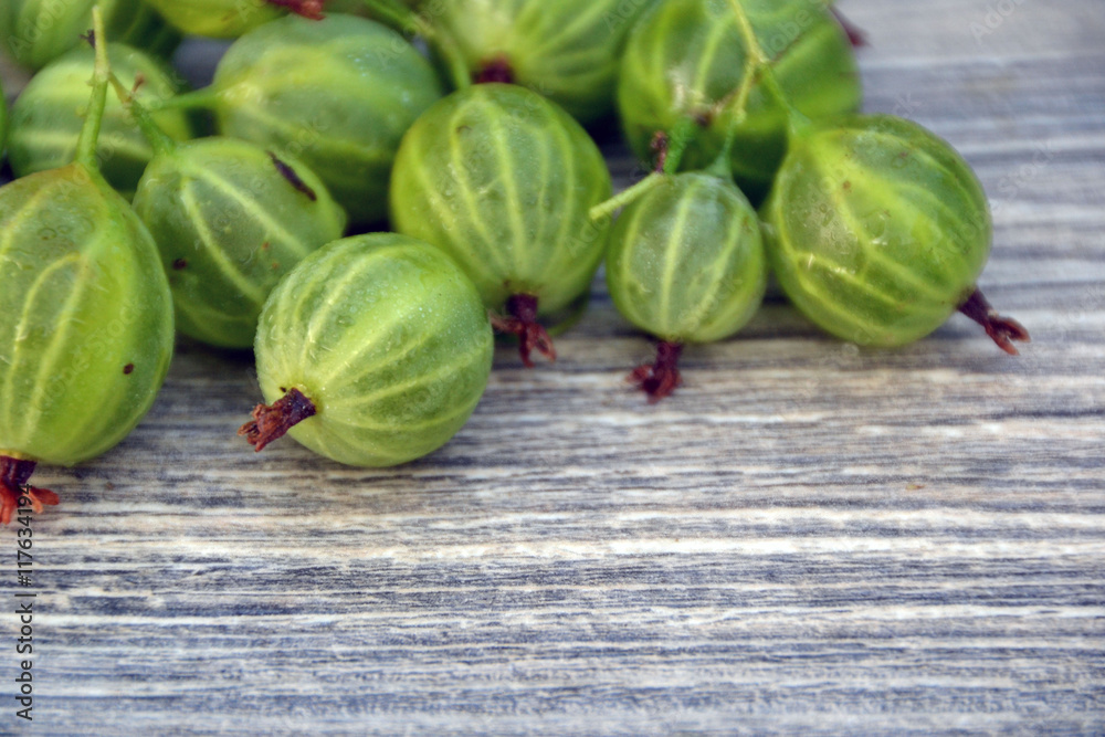 Green gooseberries on a wooden board Green gooseberries on a wooden board