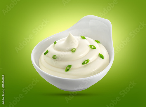 Bowl of sour cream isolated on white