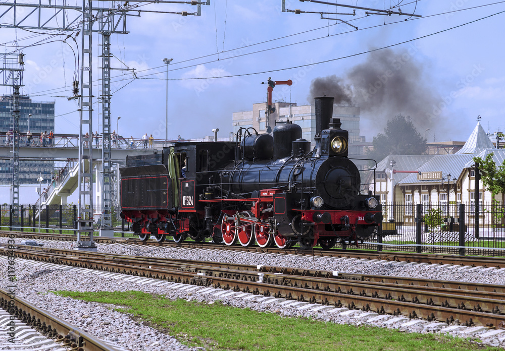 Obraz premium Demonstration of restored vintage locomotives at the celebration of the Day of railway troops of the Russian Federation in Moscow. Steam Locomotive Ov-324