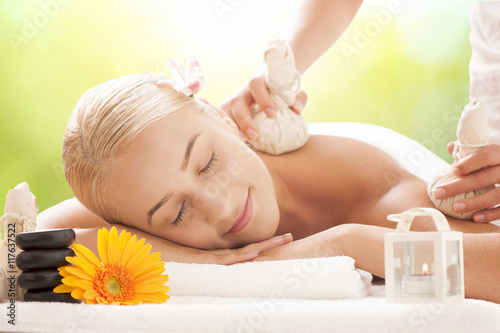 Spa and relax. A Blonde woman lying and having a massage. photo