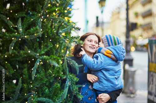 Happy family of two looking at Christmas tree