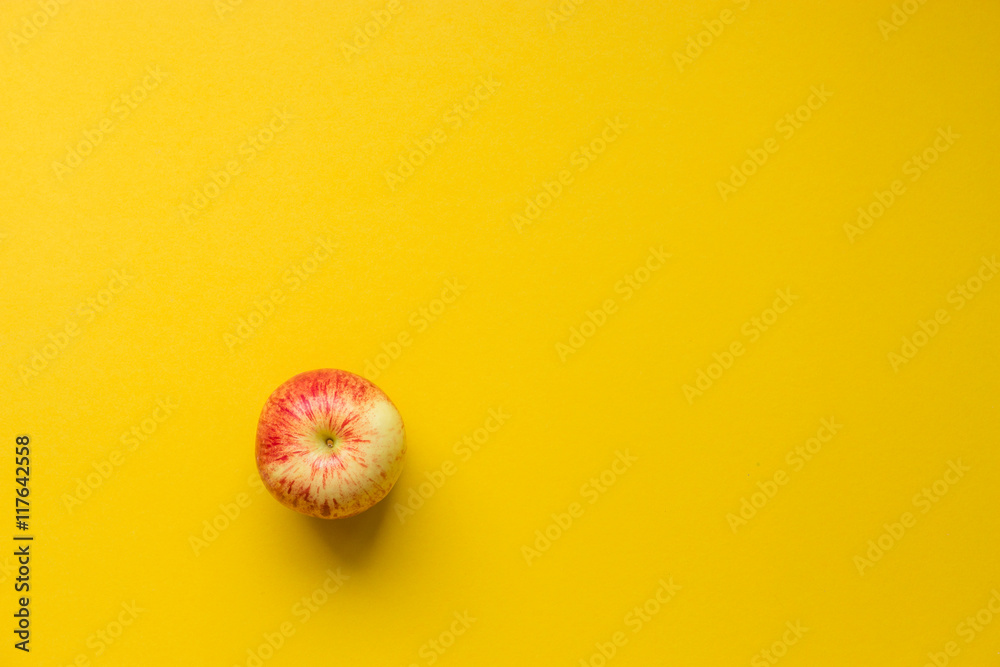 Apple on yellow background
