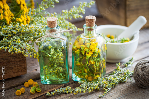 Tincture bottles of tansy and tarragon healthy herbs, absinthe h photo