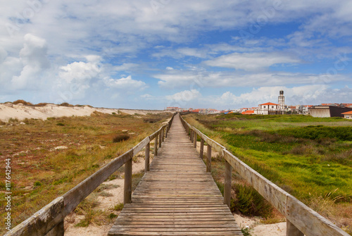 Road through sand-dunes on beach of Costa Nova, Portugal.