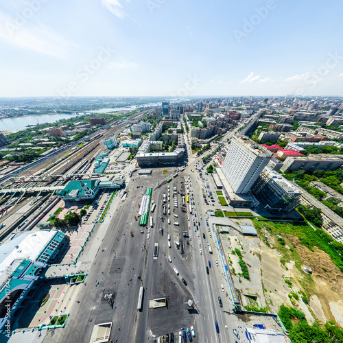 Aerial city view with crossroads and roads, houses, buildings, parks and parking lots, bridges. Urban landscape. Copter shot. Panoramic image.