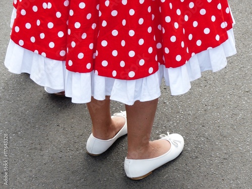 Rotes Kleid der Fünfzigerjahre mit weißen Punkten, Petticoat und weißen Ballerinas beim Oldtimertreffen Golden Oldies in Wettenberg Krofdorf-Gleiberg bei Gießen in Hessen photo