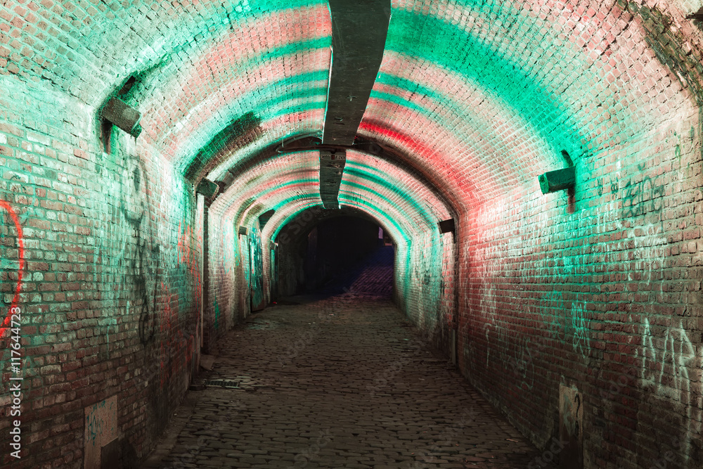 Green and pink illuminated Ganzemarkt tunnel in Utrecht, The Netherlands