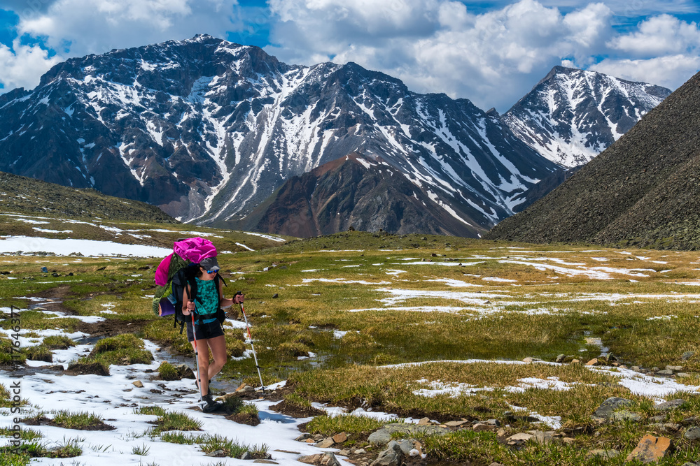 Tourist walk on snow-covered alpine meadows in tunka range