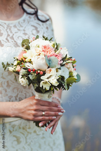 Beautiful and original bouquet of flowers in the hands of the girls